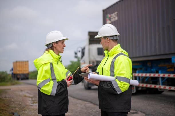istock Engineer or worker working in the construction container yard discussing or reviewing detail on tablet likely related to inspect about factory container shipping Logistics business concept. 2186572074