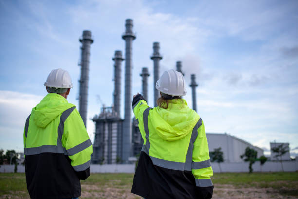 istock Engineers wearing safety gear, including hard hats examining survey a large blueprint tablet standing industrial facility gas or oil refinery engaged in a job requires high safety standards concept 2186572552