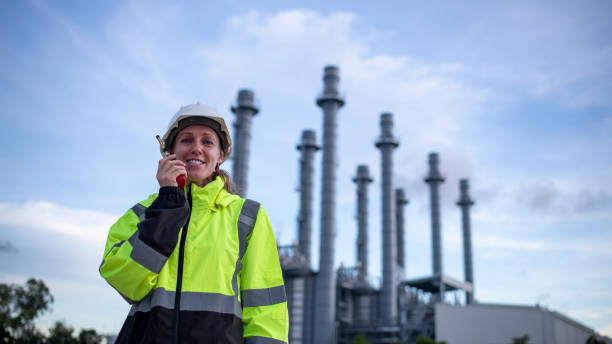 istock Engineers wearing safety gear, including hard hats examining survey a large blueprint tablet standing industrial facility gas or oil refinery engaged in a job requires high safety standards concept 2186572554