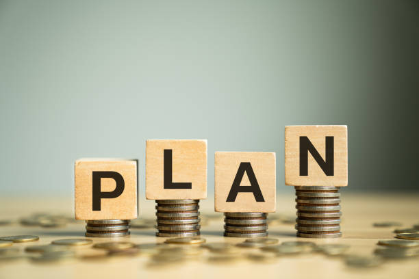 istock Wooden Block Letters Spelling PLAN Placed on Stacked Coins, Symbolizing Strategic Planning for Financial Growth, Budgeting, and Money Management in Personal and Business Finances 2186574580