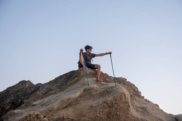 istock Young male hiker resting on mountain top at sunset 2186575163