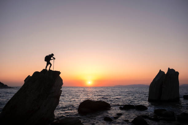 istock Hiker conquering coastal summit at sunset: embracing the majestic view 2186575168