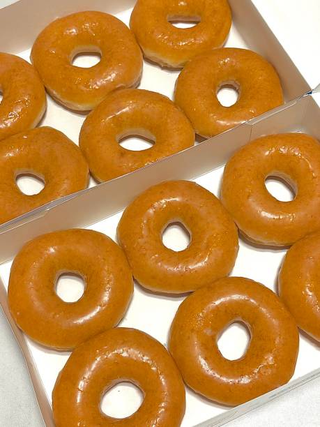 istock A classic glazed donut with a soft, fluffy texture and a sweet, glossy coating. Perfectly balanced between light and sugary, making it an irresistible treat for any time of the day. 2186575828