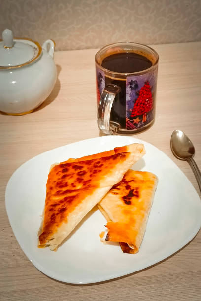 istock Baked envelopes with filling and hot coffee for breakfast. 2186578855