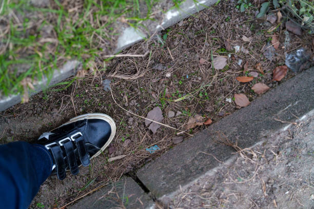 Feet with shoes that fell into the gutter