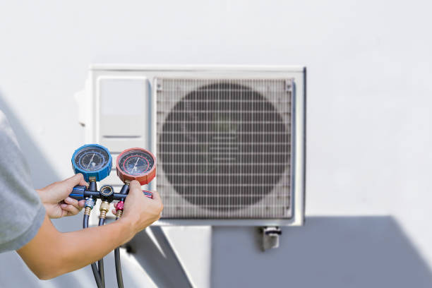 istock Air conditioning, HVAC service technician using gauges to check refrigerant and add refrigerant. 2186582668