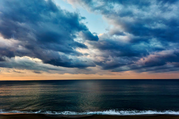 istock Scenciv iew of beach agsint dramtic sky during sunrise 2186582698