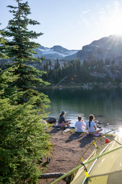 istock Mother and daughters on lakeshore by campsite 2186582900