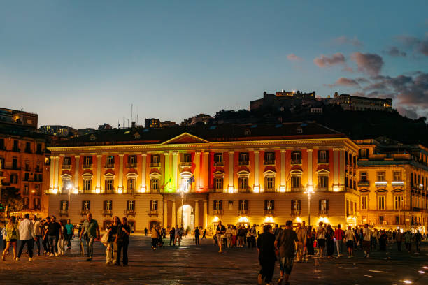 Evening Crowd Gathering in Illuminated Urban Square, Naples, Italy