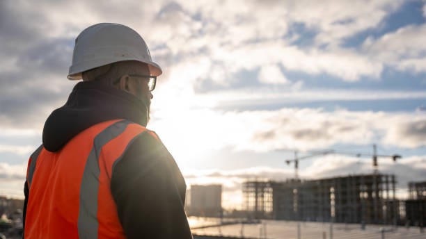 istock Construction Worker Observing Site With High-Rise Buildings 2186584959