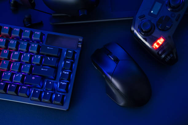 istock gamer work space concept, top view a gaming gear, mouse, keyboard, joystick, headset, mobile joystick, in ear headphone and mouse pad on black table background. 2186585250