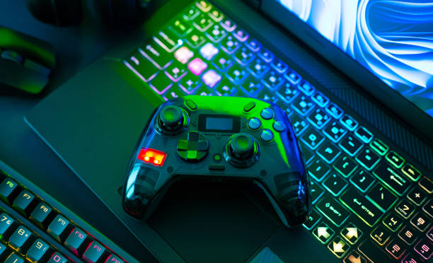 istock gamer work space concept, top view a gaming gear, mouse, keyboard, joystick, headset, mobile joystick, in ear headphone and mouse pad on black table background. 2186585251