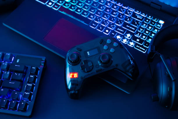 istock gamer work space concept, top view a gaming gear, mouse, keyboard, joystick, headset, mobile joystick, in ear headphone and mouse pad on black table background. 2186585252
