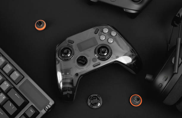 istock gamer work space concept, top view a gaming gear, mouse, keyboard, joystick, headset, mobile joystick, in ear headphone and mouse pad on black table background. 2186585258