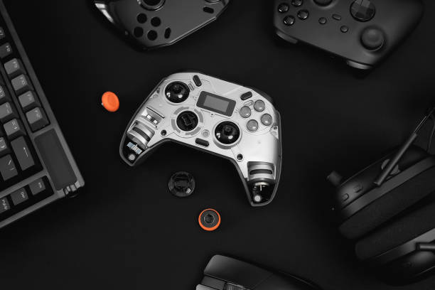 istock gamer work space concept, top view a gaming gear, mouse, keyboard, joystick, headset, mobile joystick, in ear headphone and mouse pad on black table background. 2186585259