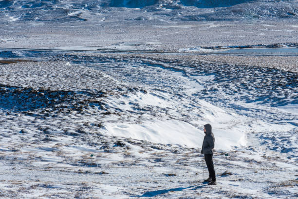 istock Man walking through a snowy desert landscape 2186586811