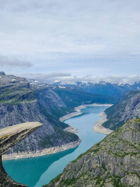 istock Trolltunga surrounded by steep mountains in Norway during a cloudy afternoon 2186587947