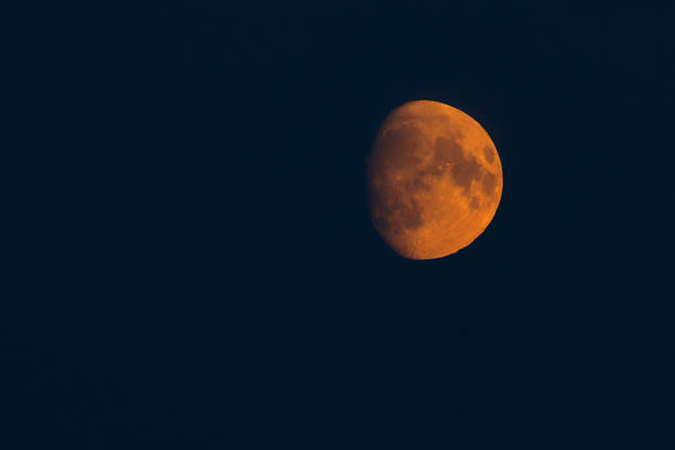 round red moon at night against a black sky