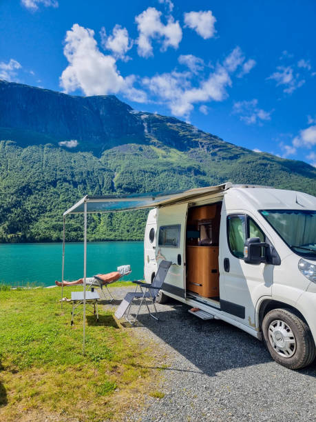 istock Enjoying a serene lakeside moment in a camper van under a bright blue sky in Norway 2186591051