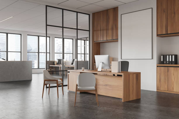 istock Modern office interior with computer desk and chairs, framed mockup on the wall, and large windows in background. 3D Rendering 2186591202