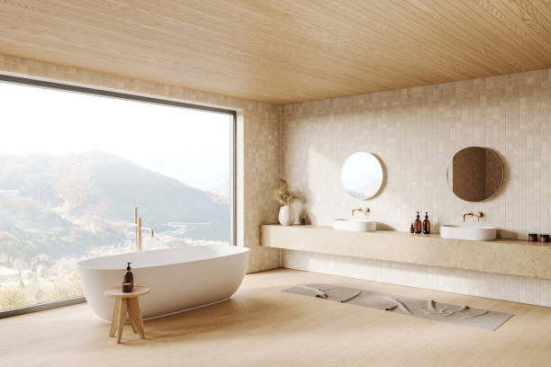 istock Spacious bathroom featuring a large window, wooden ceiling, freestanding bathtub, double sinks, round mirrors. Concept of modern interior design. 3D Rendering 2186592193