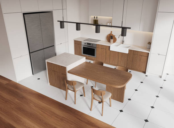 istock A modern kitchen interior featuring wooden cabinets, a central island with seating, and sleek appliances. The room has a clean, contemporary look. 3D Rendering 2186592384