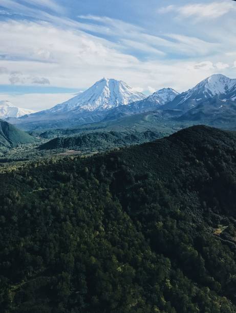 istock Snow-capped mountains with green valleys 2186594925