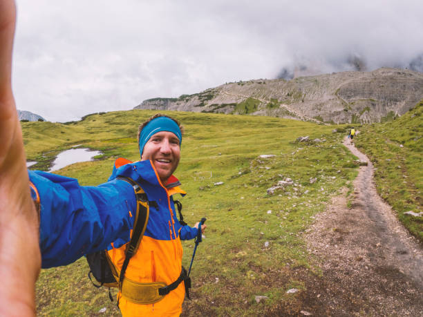 istock Adventurer Taking a Selfie on a Mountain Trail on a Rainy Day 2186595537