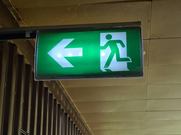 istock Green exit sign with a running person icon indicating the way out 2186598934