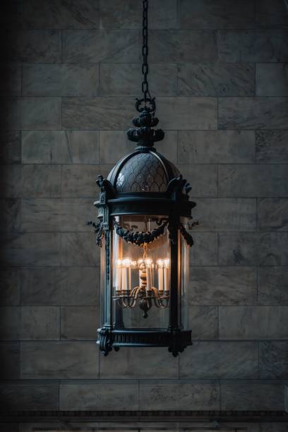istock Vintage chandelier with glowing bulbs and intricate design. 2186600578