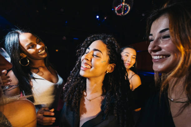 istock Joyful young women enjoying a vibrant night out dancing 2186600868