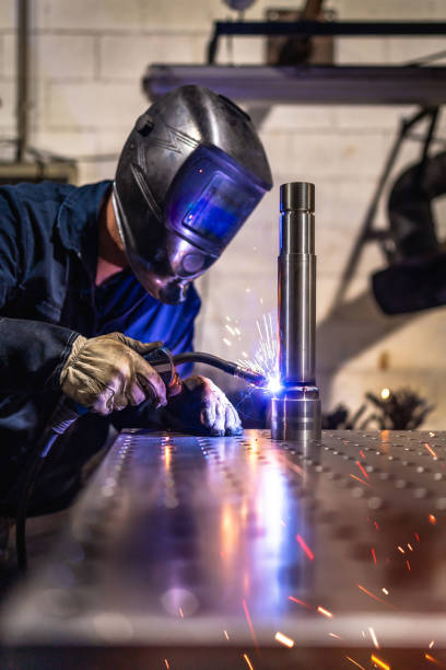 istock Welder with protective gear working in a factory 2186600954