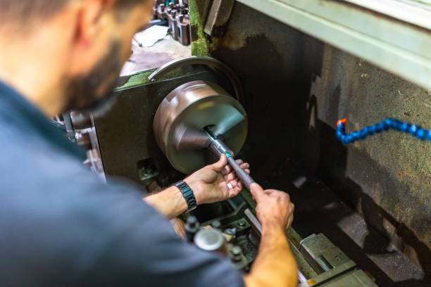 Man working with manual lather in factory