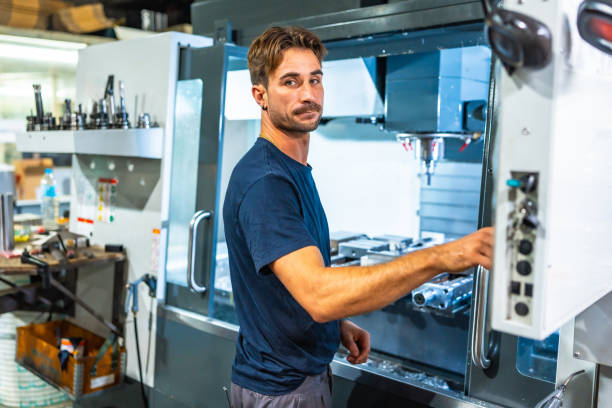 Man using mechanical machine to shape plastic in cnc factory