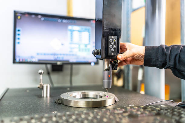 Technician working with three-dimensional verification and measuring machine Close-up of the hand of a technician working with three-dimensional verification and measuring machine in a cnc innovative metal factory cnc machine stock pictures, royalty-free photos & images