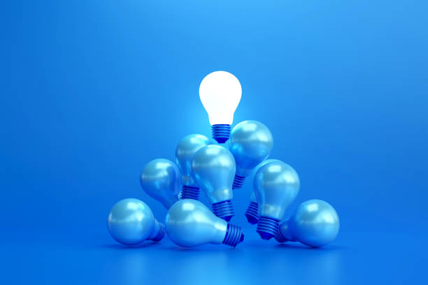 istock Distinctive shine bright light bulb floats above the blue light bulb. 2186601676