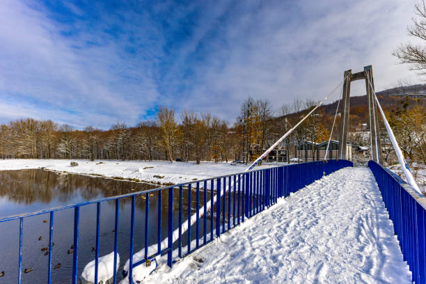 Granite stairs and terrace over the river under snow in winter.