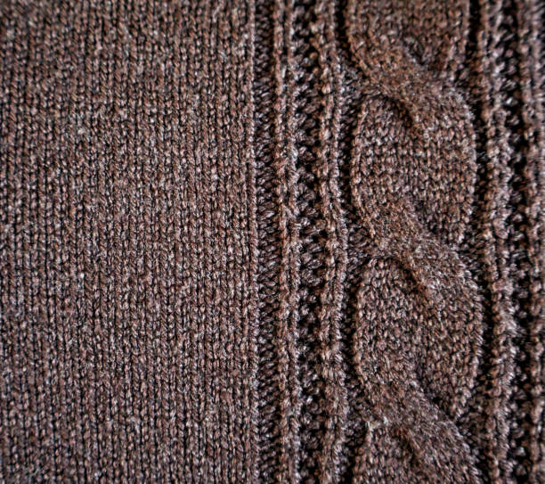 istock Close-Up of Brown Knitted Fabric with Cable Pattern 2186603336