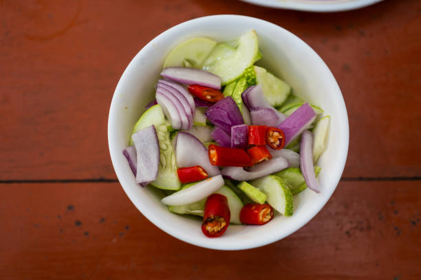 Ajad, or a side dish to eat with pork stew, is made from sliced cucumbers. Sugar simmered with vinegar Add chopped bell pepper and onion.