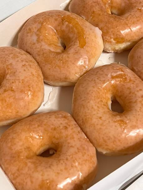 istock A classic glazed donut with a soft, fluffy texture and a sweet, glossy coating. Perfectly balanced between light and sugary, making it an irresistible treat for any time of the day. 2186609305