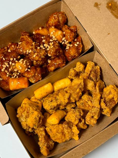 Crispy Korean fried chicken, perfectly glazed with a sweet and spicy sauce. Ideal for food photography and menus, showcasing the irresistible crunch and flavor of this beloved dish.
