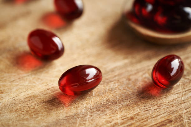 istock Red krill oil pills or globules on a wooden table 2186610856