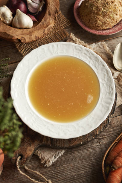 istock Chicken bone broth in white plate on a wooden table 2186610880