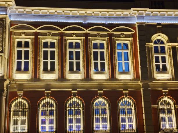 istock brown house facade with illuminated elongated windows divided into squares 2186610965