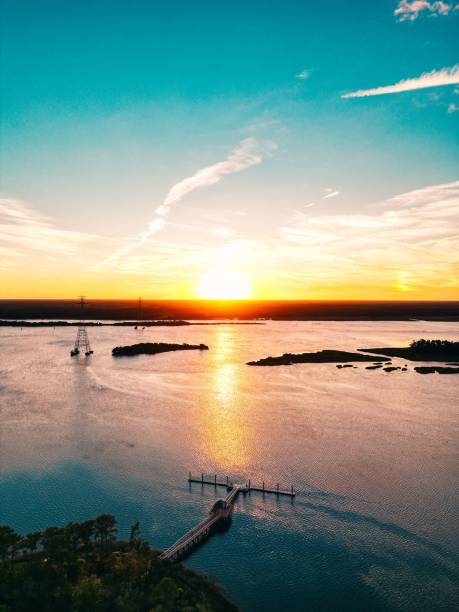 istock Sunset over a serene lake with a pier. 2186611960