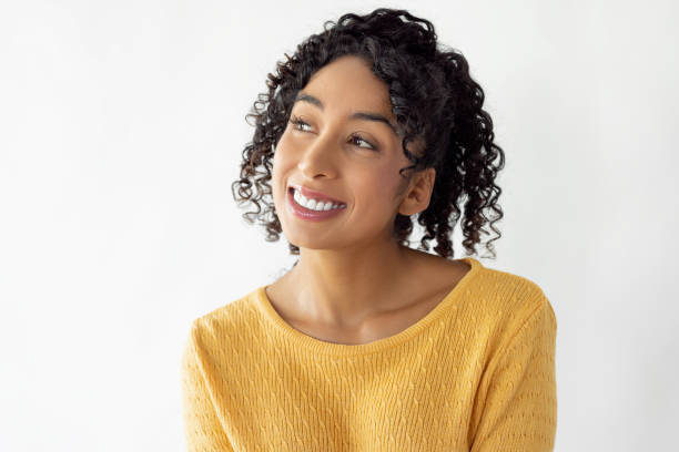 istock Young woman smiling and looking away 2186614681