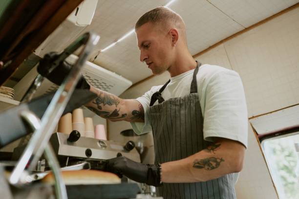 istock Male Cook Frying Buns 2186618420