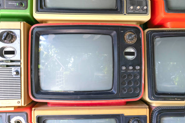 Retro of pile old television on floor in room, wall background. Classic, vintage old obsolete TV with empty screen.