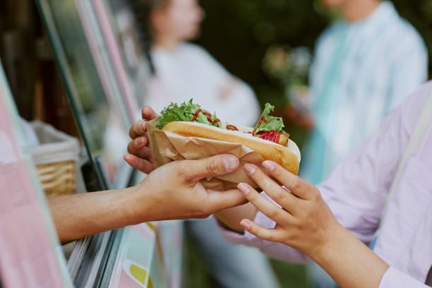 istock Hot Dog in Female Hands 2186622046