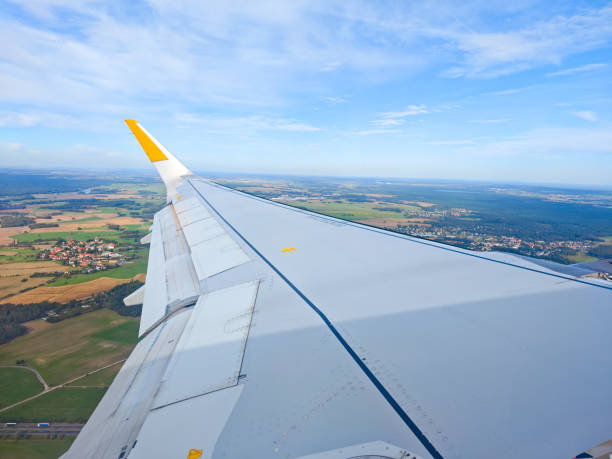 istock air plane wing agains the sky 2186623725
